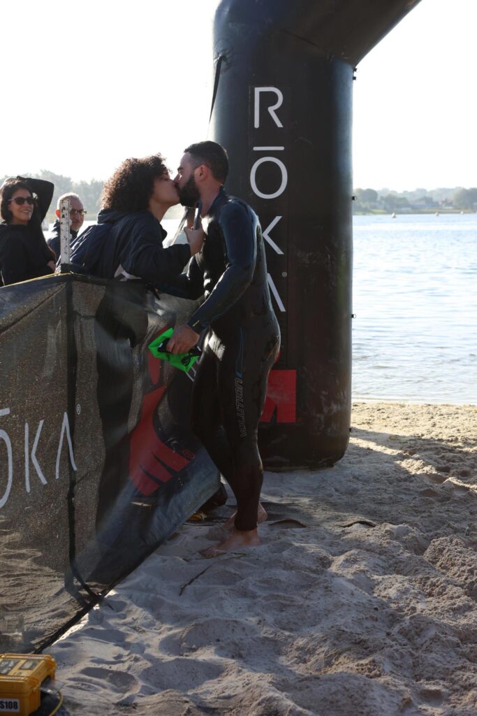 Me kissing Alex, my girlfriend, after coming out of the lake during my Ironman 70.3.