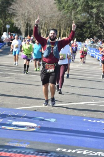 Alain crossing the finish line at a runDisney marathon in 2024. For the post about completing your first marathon.